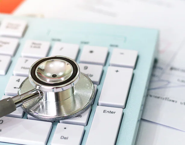 closeup of a stethoscope on a computer keyboard