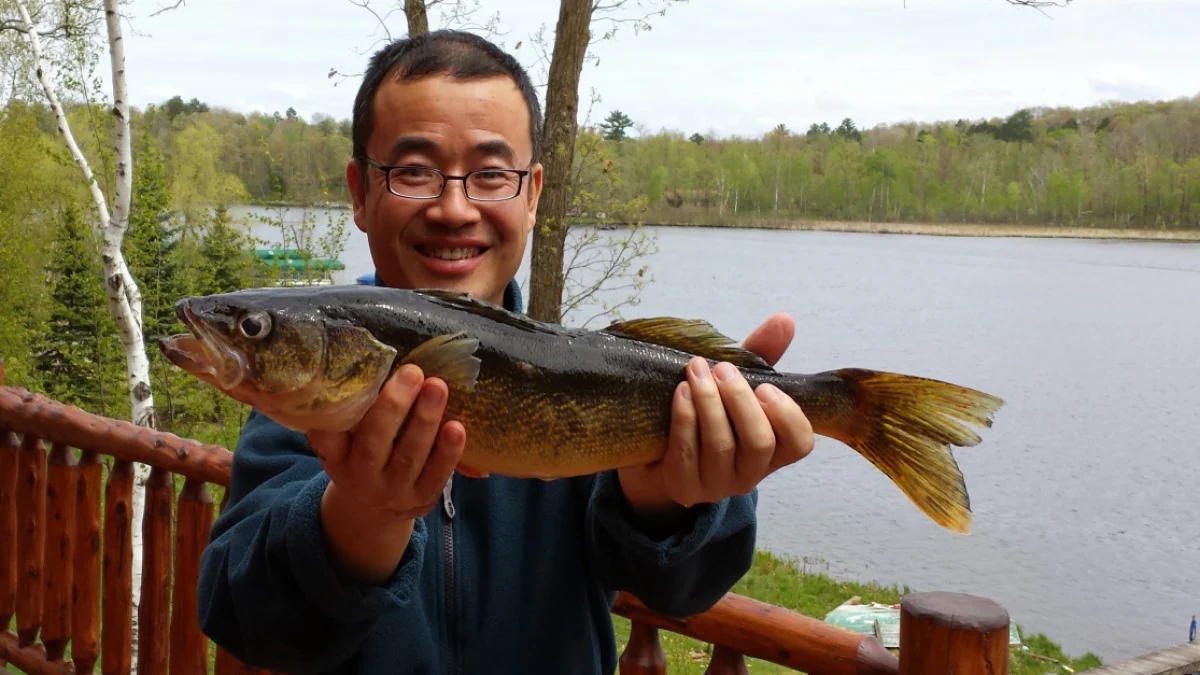 Man holding up a fish that he caught