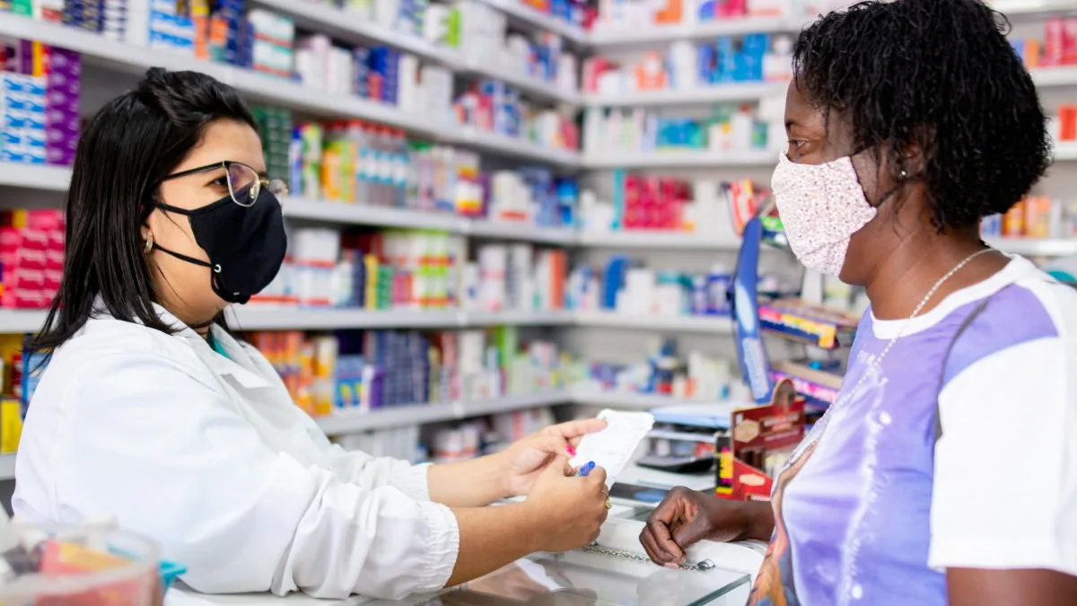 a pharmacist talking to a patient about her prescription