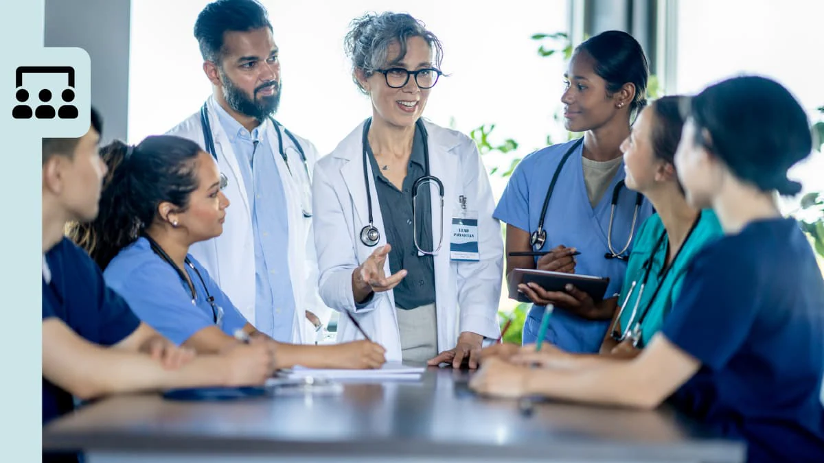 A group of healthcare professionals gathered in a meeting.