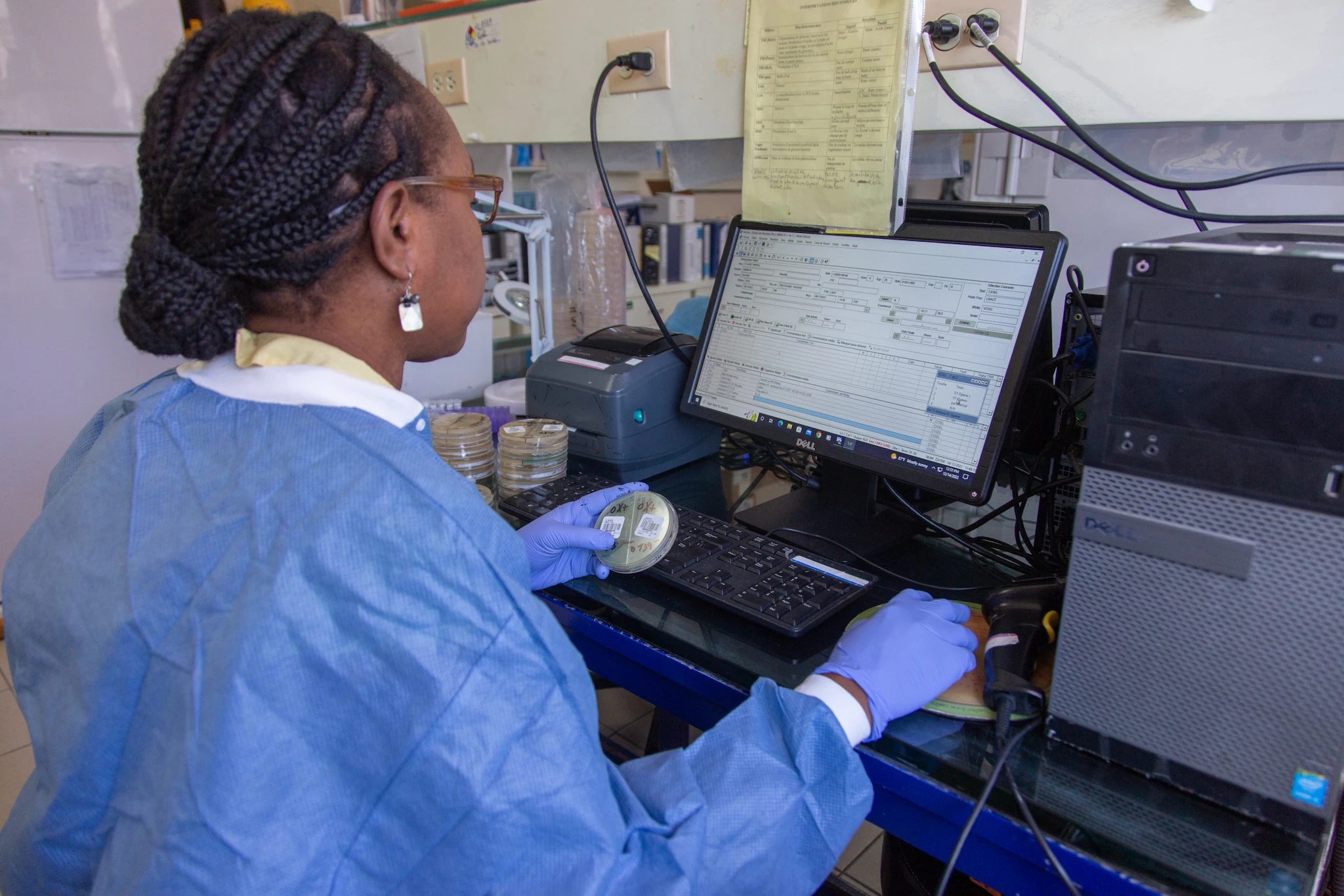 Laboratory worker registers stools samples on a computer. @UNICEF/U.S.CDC/UN0771521/Rouzier