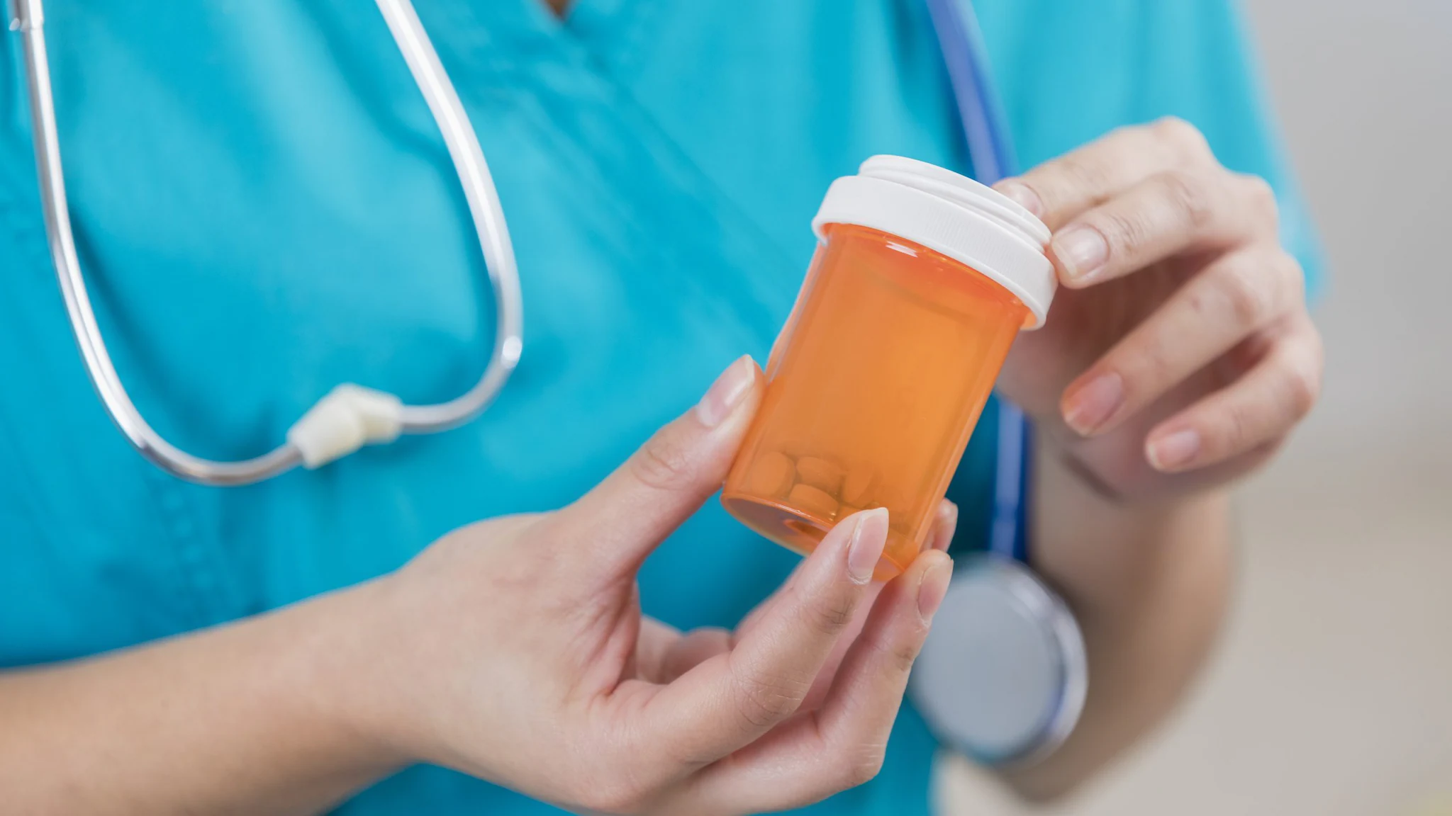 Nurse holding a bottle of pills