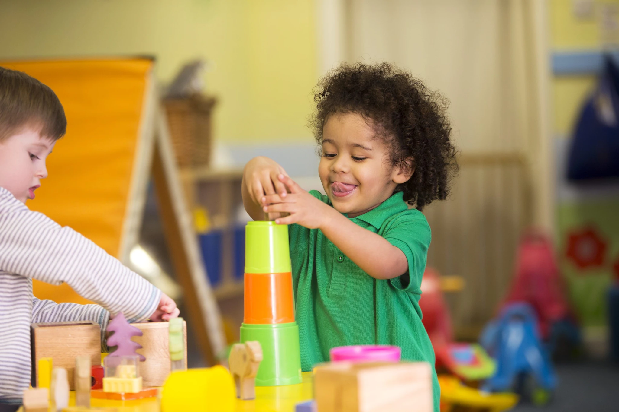 Young children playing with blocks at a childcare facility.