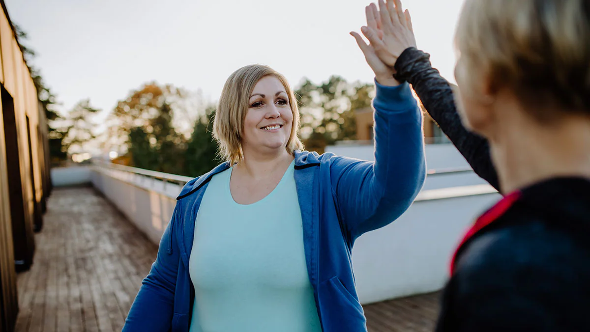 woman high fiving an exercise partner