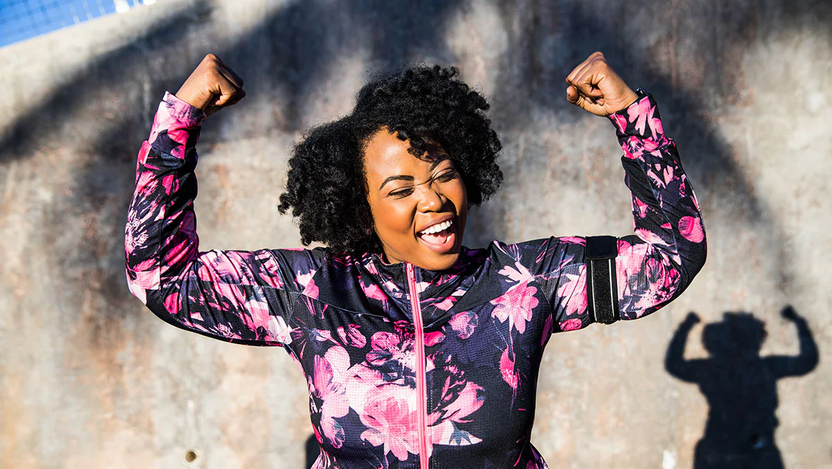 African American woman raising her arms