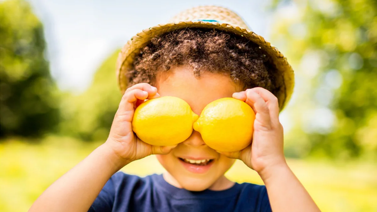 Child playing on a slide from the cover of the 2023 Achieving a State of Healthy Weight report.