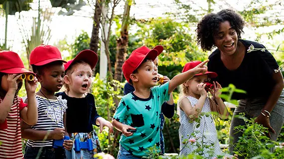 Children in garden with their teacher.