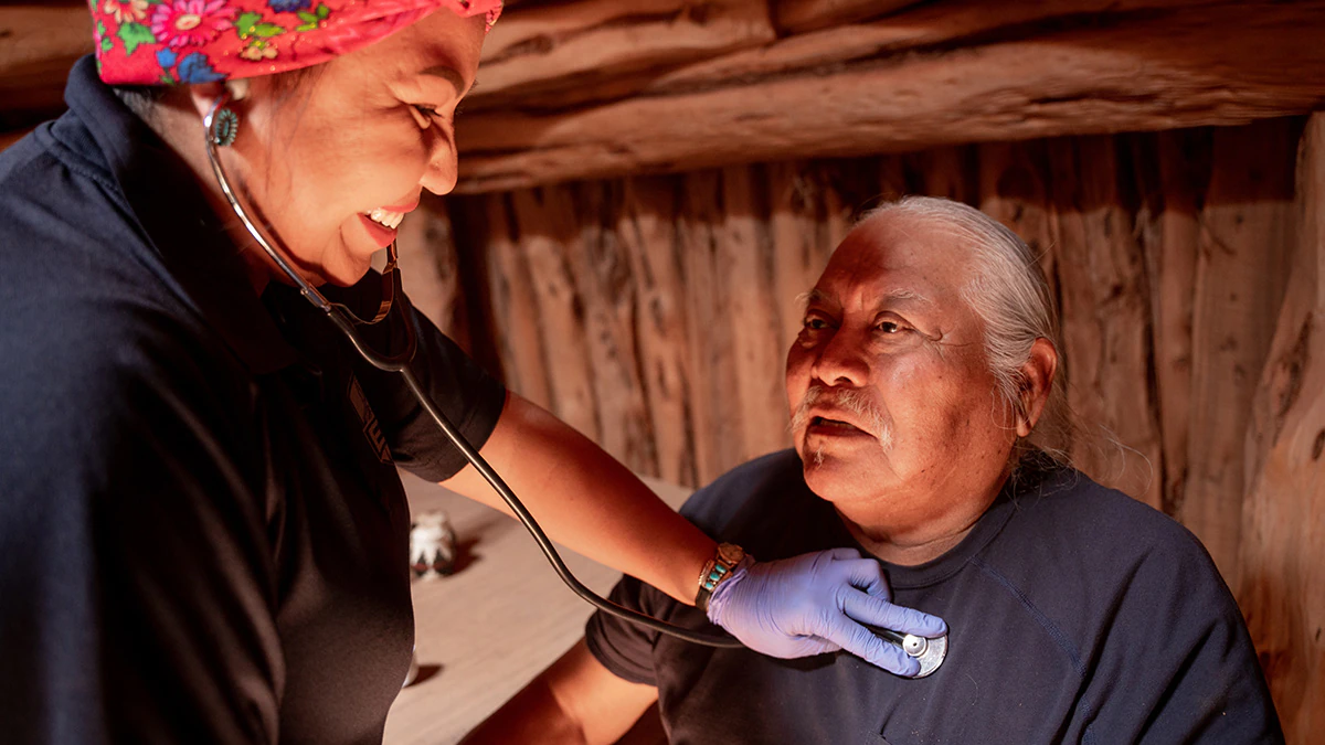 A healthcare provider uses a stethoscope with a patient