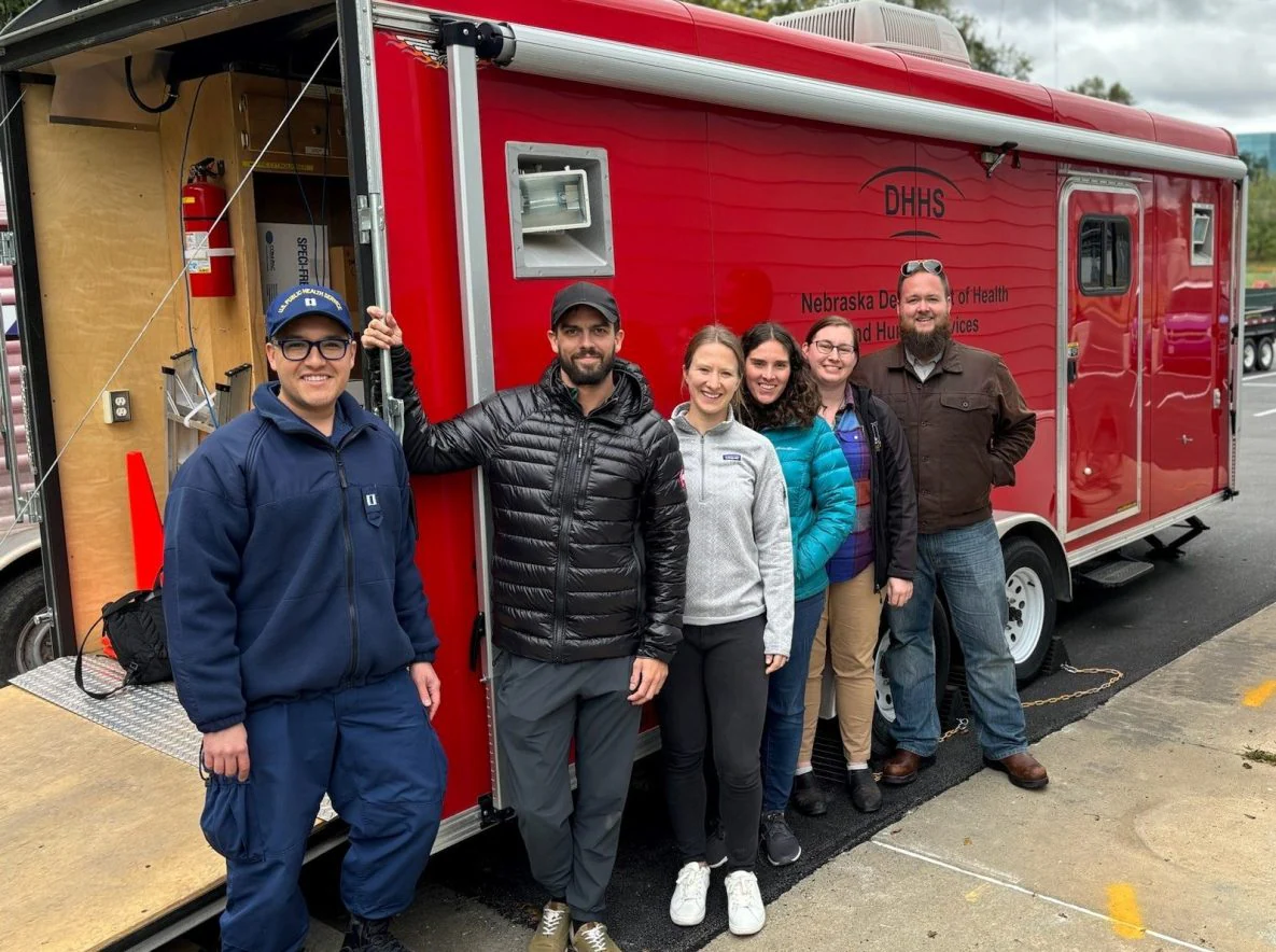 EIS officers posing in front of mobile testing lab for enhanced rabies surveillance