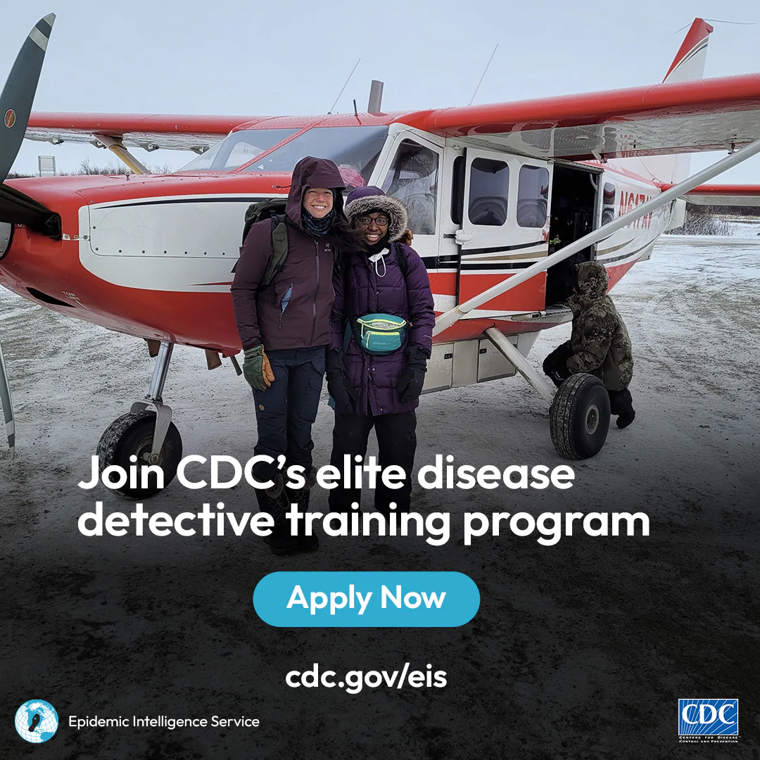 Two EIS Officers boarding a small plane in the snow.