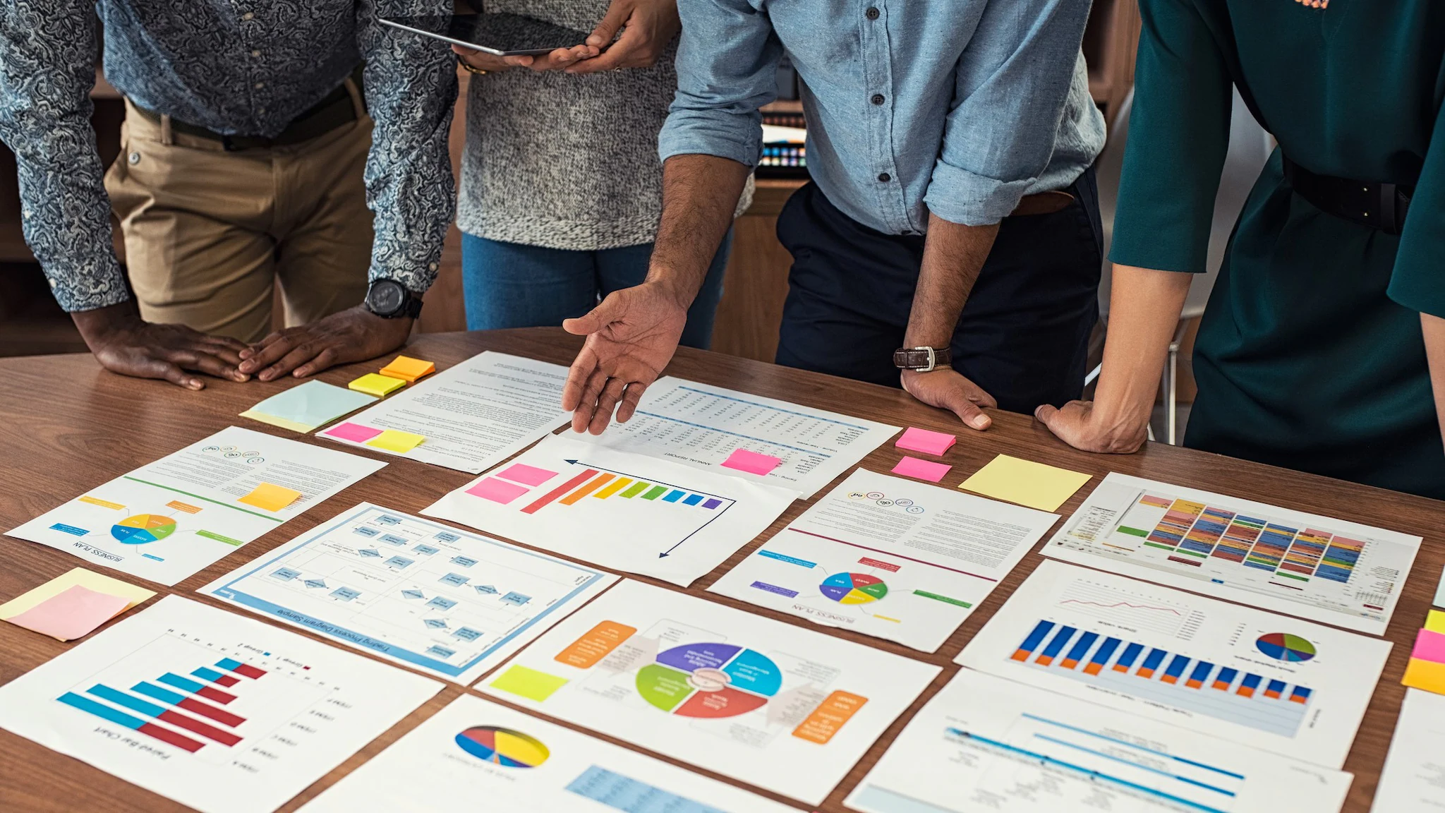 People around a table with data and charts.