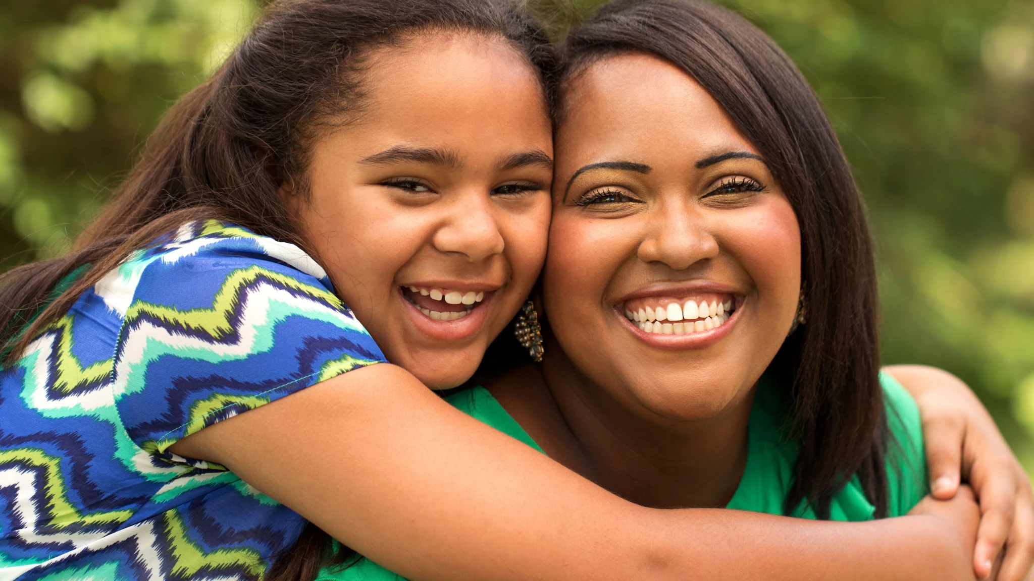 Mother and daughter hugging each other.