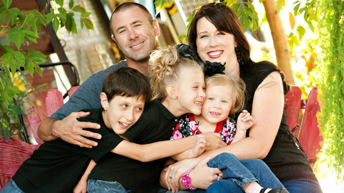 family sitting together with three kids that have fxs