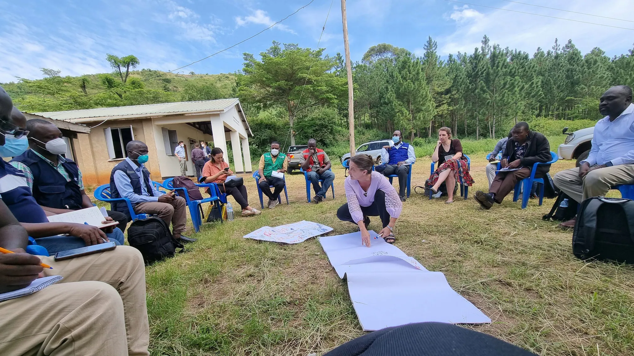 Dr. Amy Boore helps coordinate surveillance activities with partners in an outdoor meeting