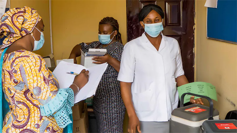 Public health workers prepare COVID-19 vaccines for distribution at local vaccination clinics in Abuja, Nigeria