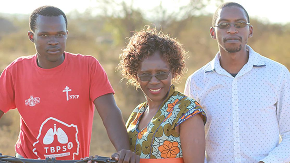 Photo of three individuals standing side-by-side working on the TB response in Eswatini