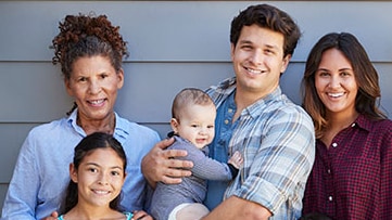 A mother and father with their two children and a grandparent