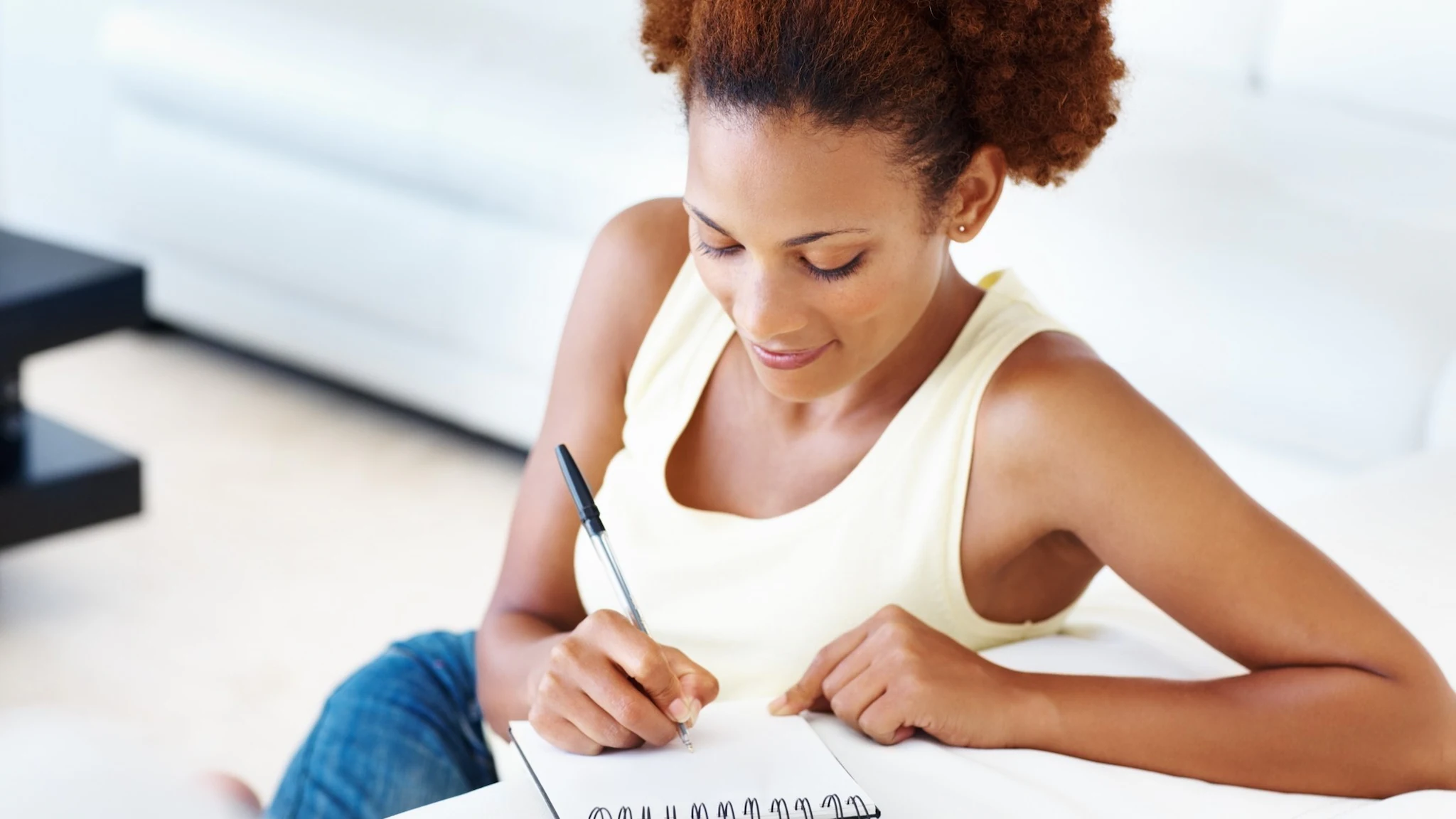 A woman writes in a journal.