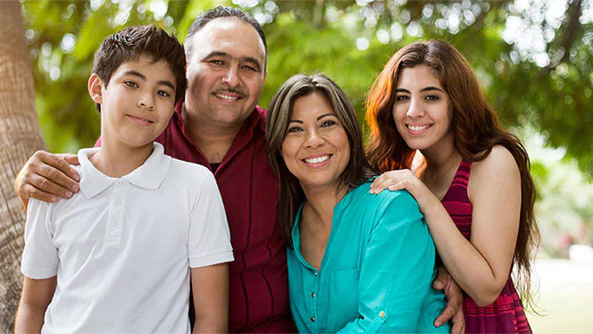 A family portrait photo of parents and teens.