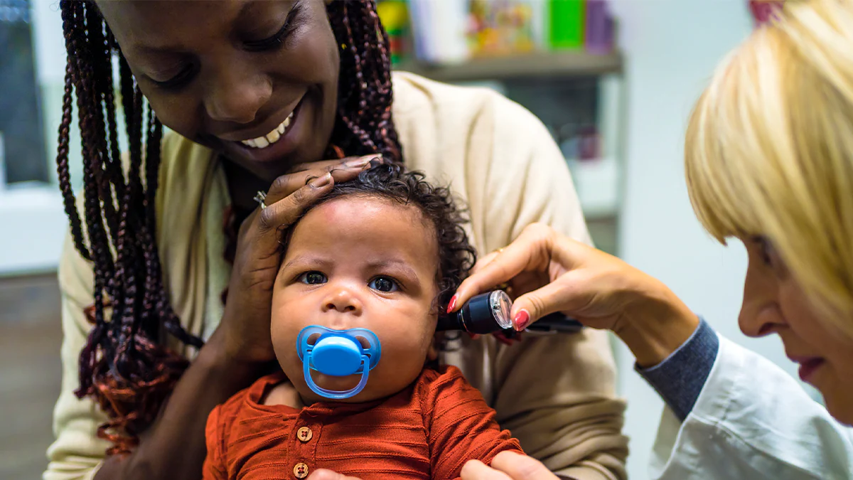 baby getting their ears checked at the doctor's office