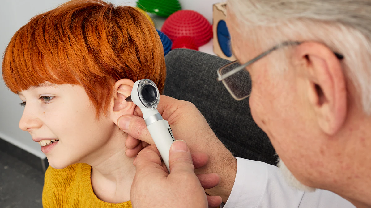 A young boy getting ear exam