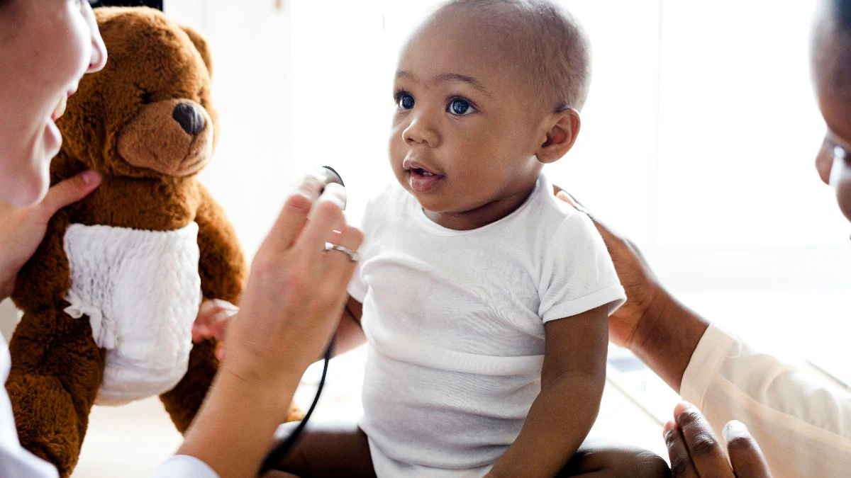 doctor listening to boy's heart