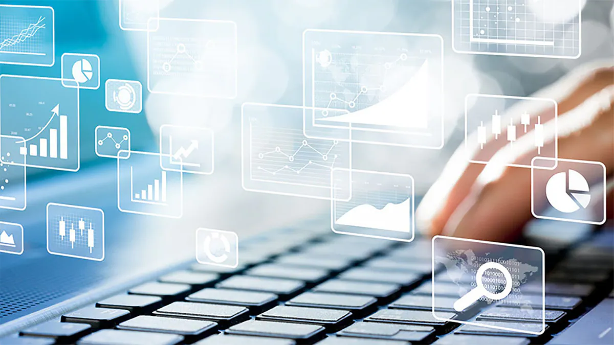 Charts, magnifying glass, and data floating over a keyboard