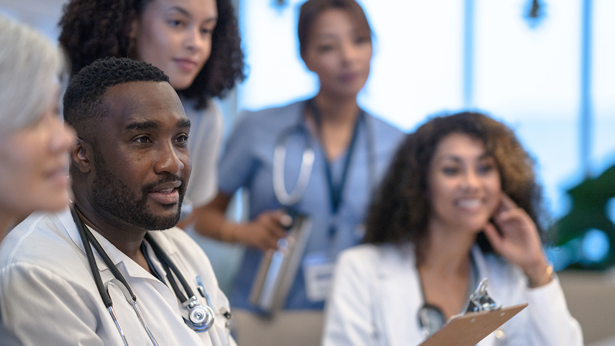 A group of healthcare professionals sitting in a meeting