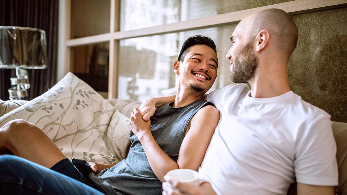 People Coinfected with HIV and Hepatitis Two men snuggled on couch coinfected with HIV and viral hepatitis