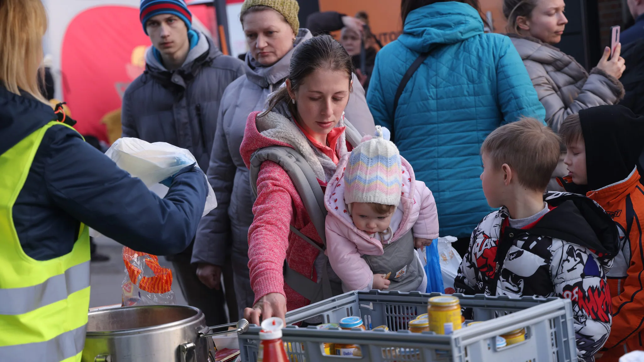 Mother and child collecting food at a shelter.