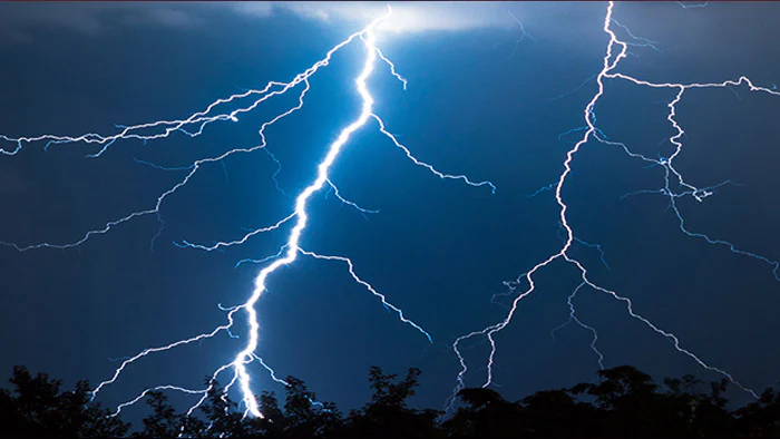 Lightning strikes against dark, stormy sky.