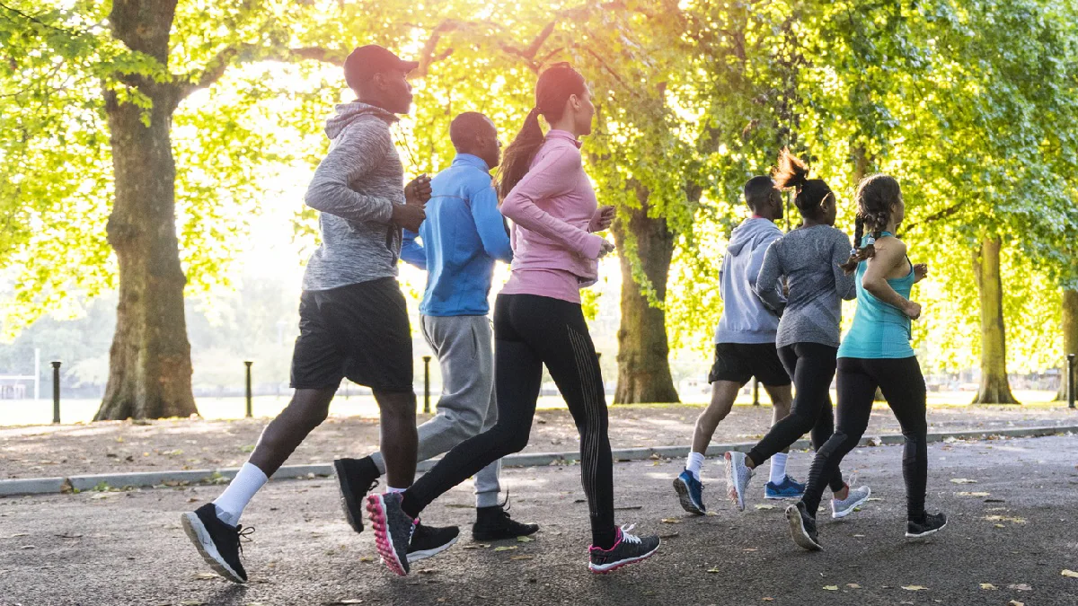 Group of 6 people jogging in a park