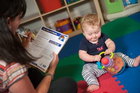 Mom using checklist with baby 9 months old