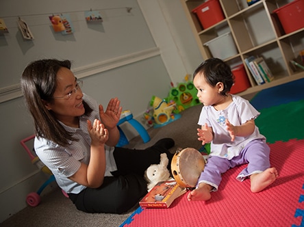 A one-year-old performing a milestone: copies gestures