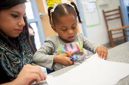 A girl using scissors at school