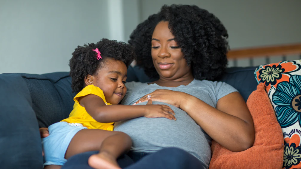 Pregnant mother and young daughter