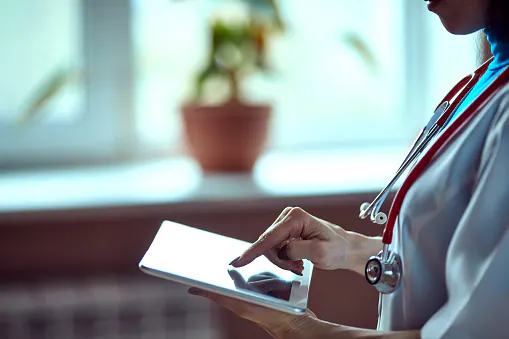 Woman doctor using tablet computer in hospital