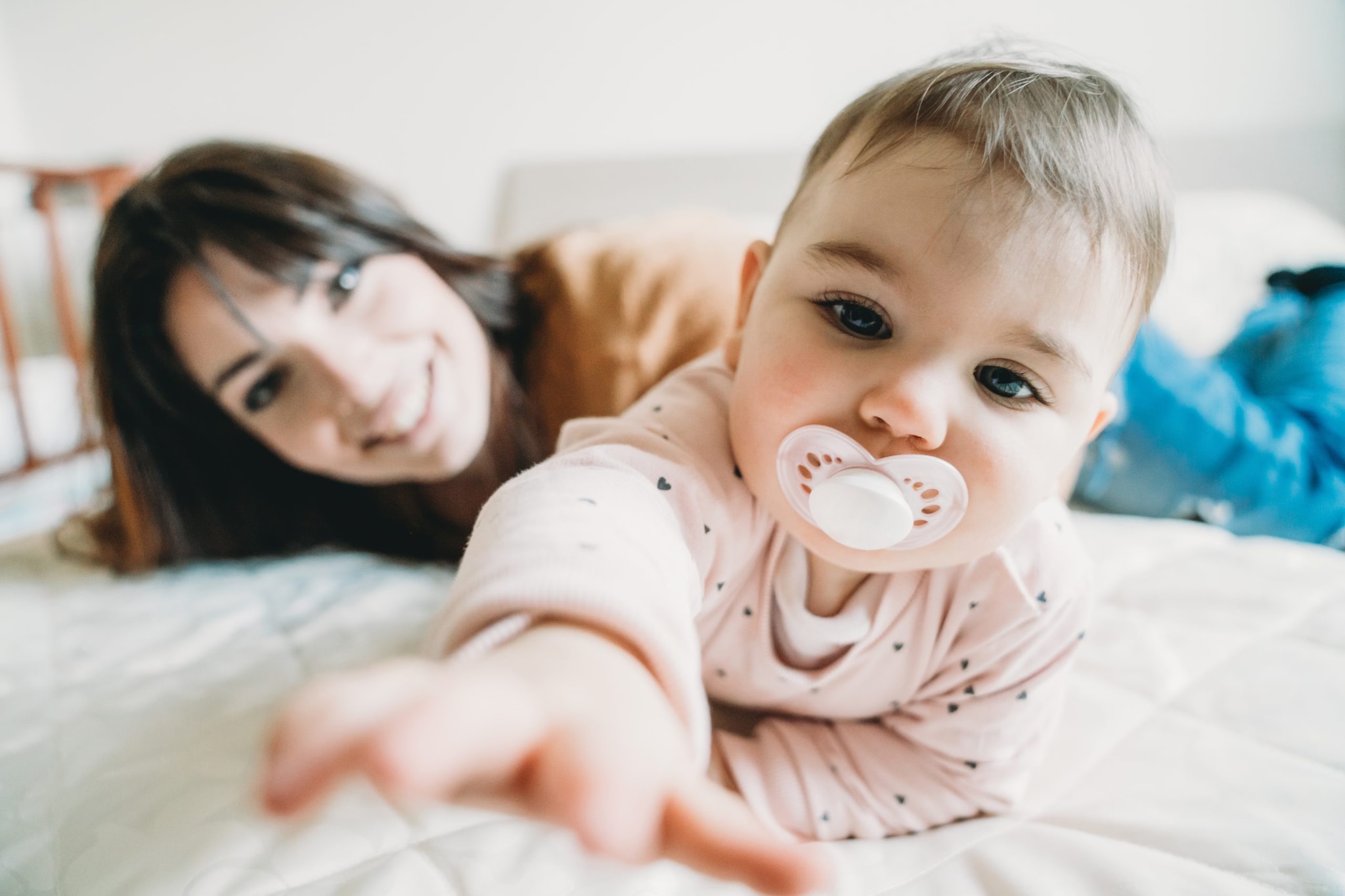 Mother and infant on bed