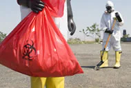 two workers picking up waste