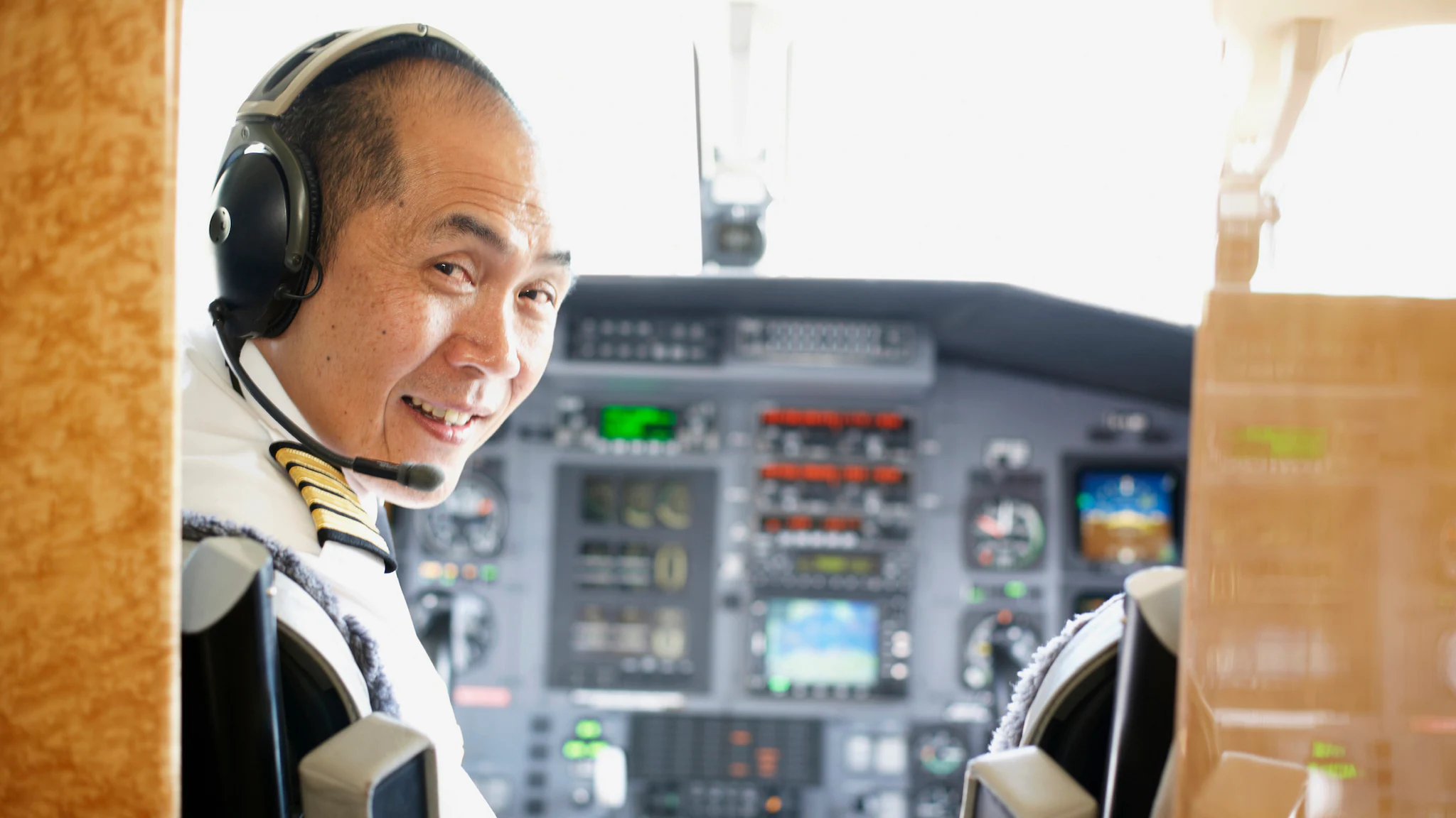 Close up of a pilot sitting in the cockpit of a plane.