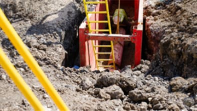 Trenching Trench with a yellow ladder.