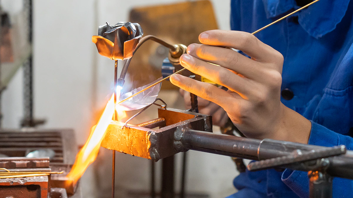 Close-up of a worker's hands working with lead.