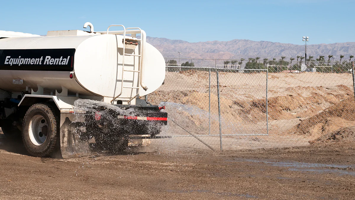 Truck spraying water on the soil to control dust