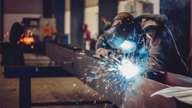 Industrial welder with a torch.