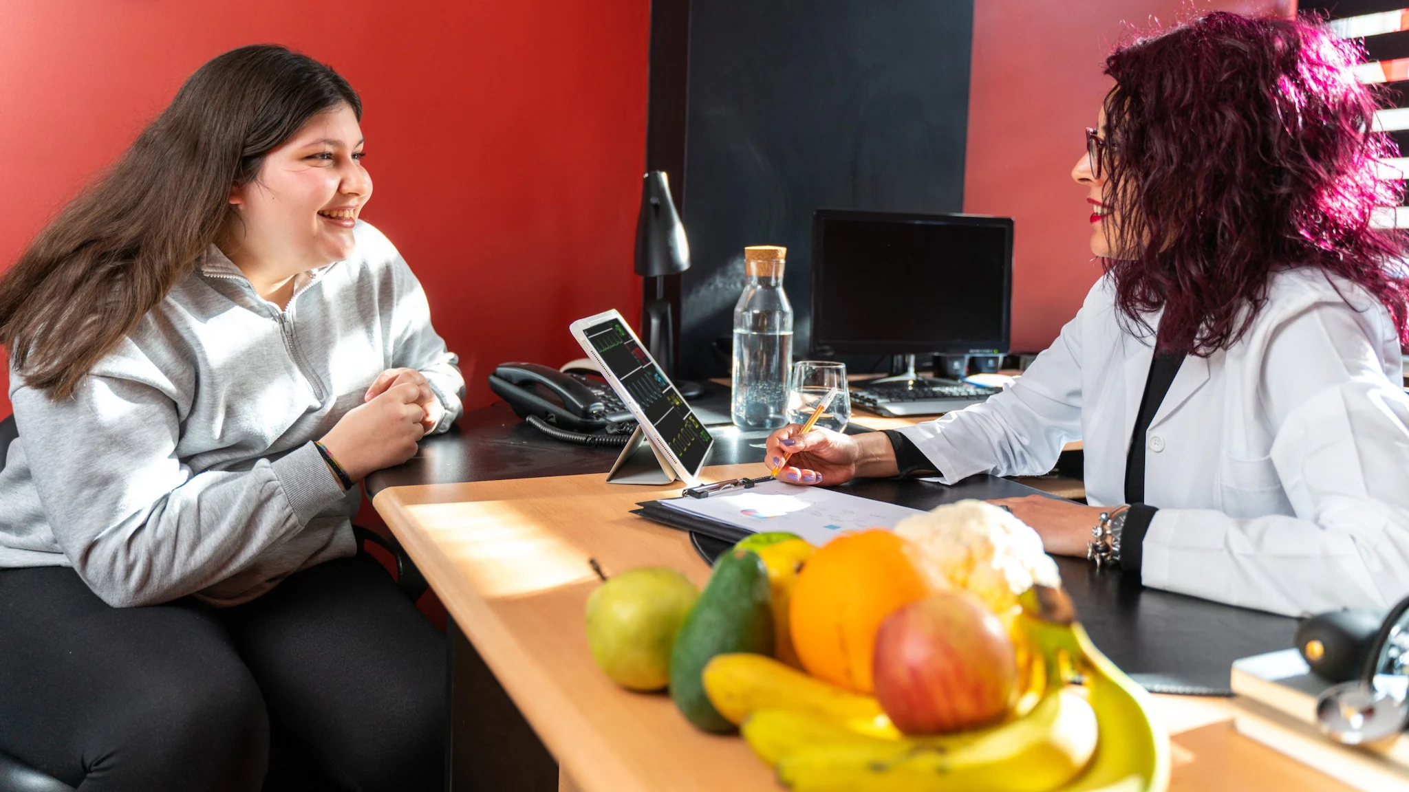 pre-teenage girl talking with female healthcare provider