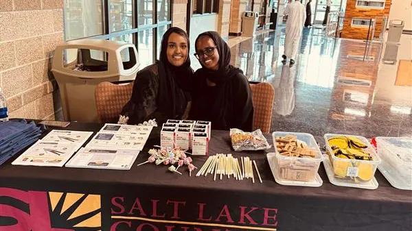 Ayan (left) and Halima (right) tabling at a graduation event for Somali residents completing their Koran study courses.