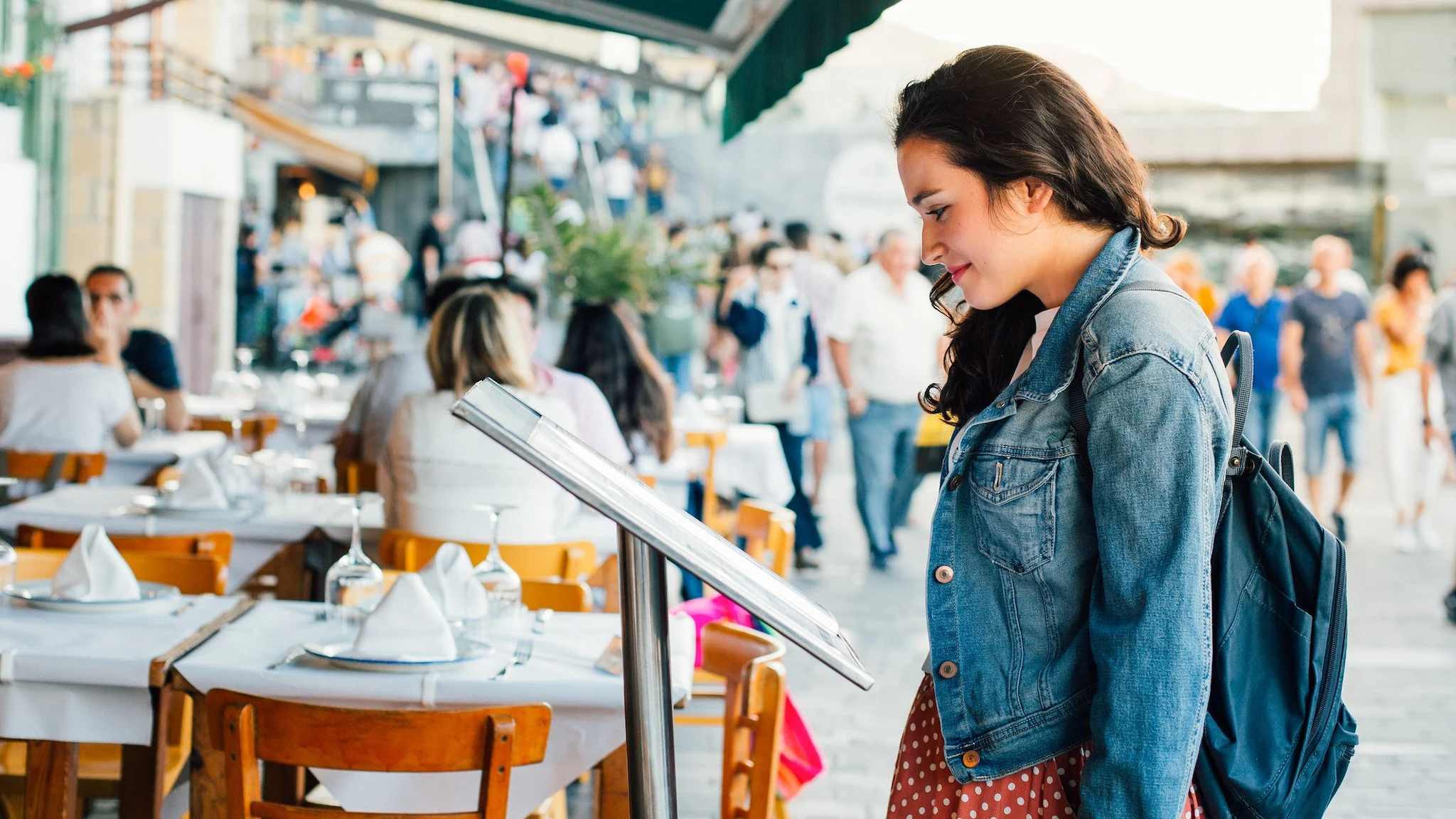 Person looking at a menu outside a restaurant