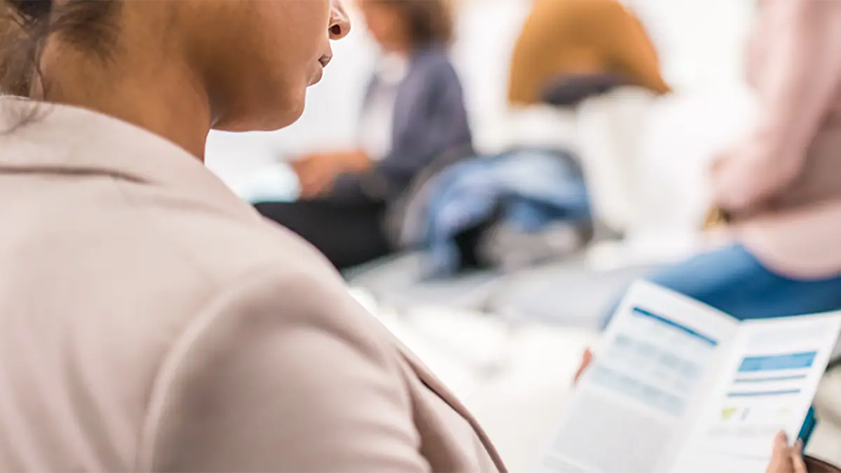 Photo of a woman with a fact sheet.