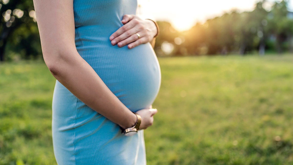 Pregnant woman holding stomach