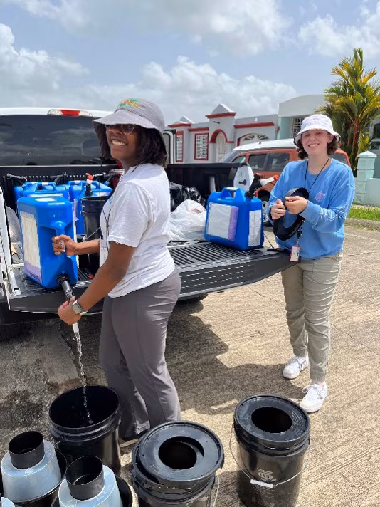 PHEFA participants in the field PHEFA participants fill mosquito traps with water for field research in Puerto Rico.